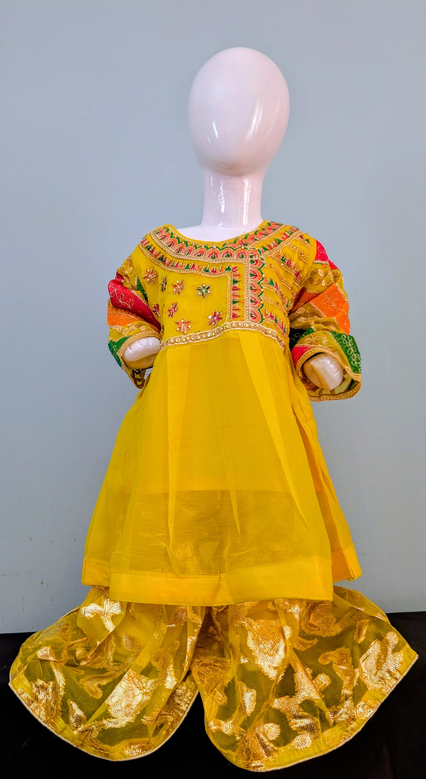 Girls' yellow silk embroidered frock with soft inner and matching yellow and gold gharara.