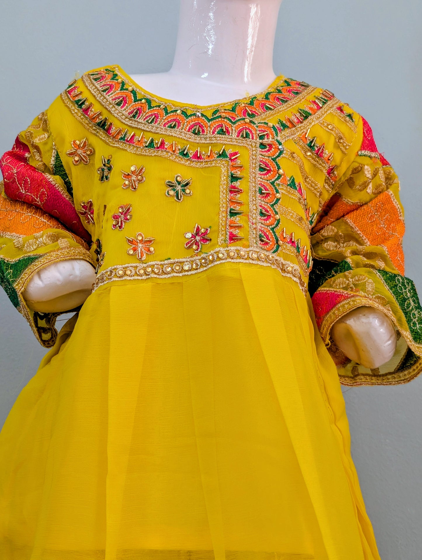 Girls' yellow silk embroidered frock with soft inner and matching yellow and gold gharara.