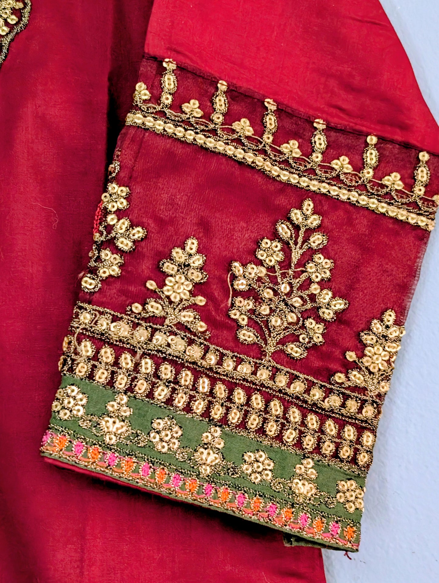 Girls maroon fully embroidered lawn kurta with matching trouser and gold dupatta.