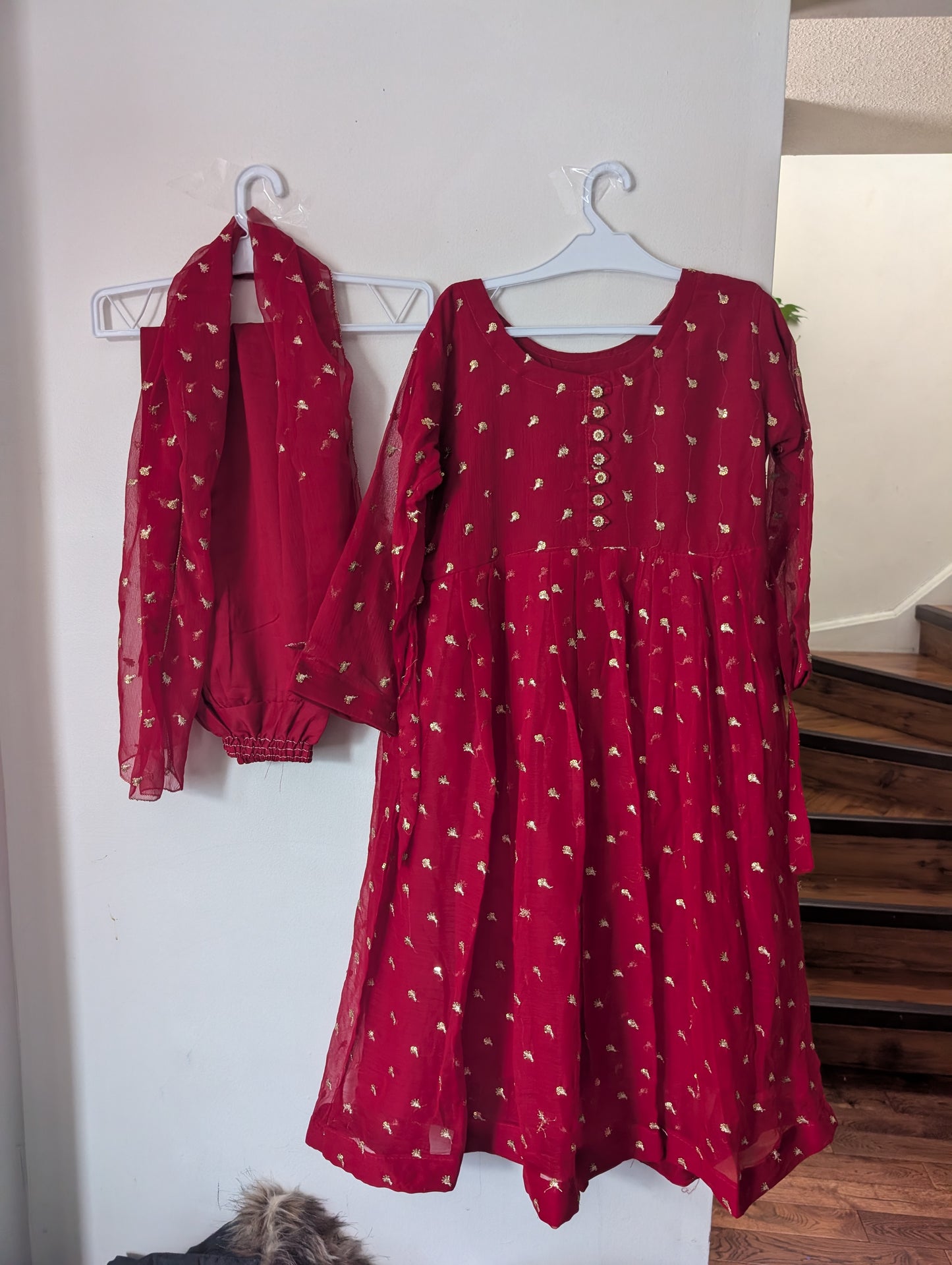 Girls shafoon gold-embellished traditional red outfit and dupatta.