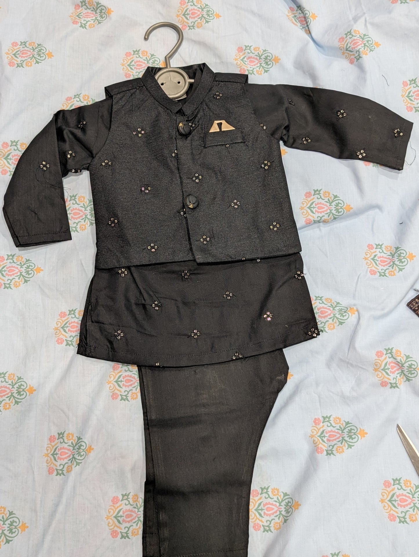 Infant black traditional embroidered waistcoat, a matching kurta, and coordinating pants,