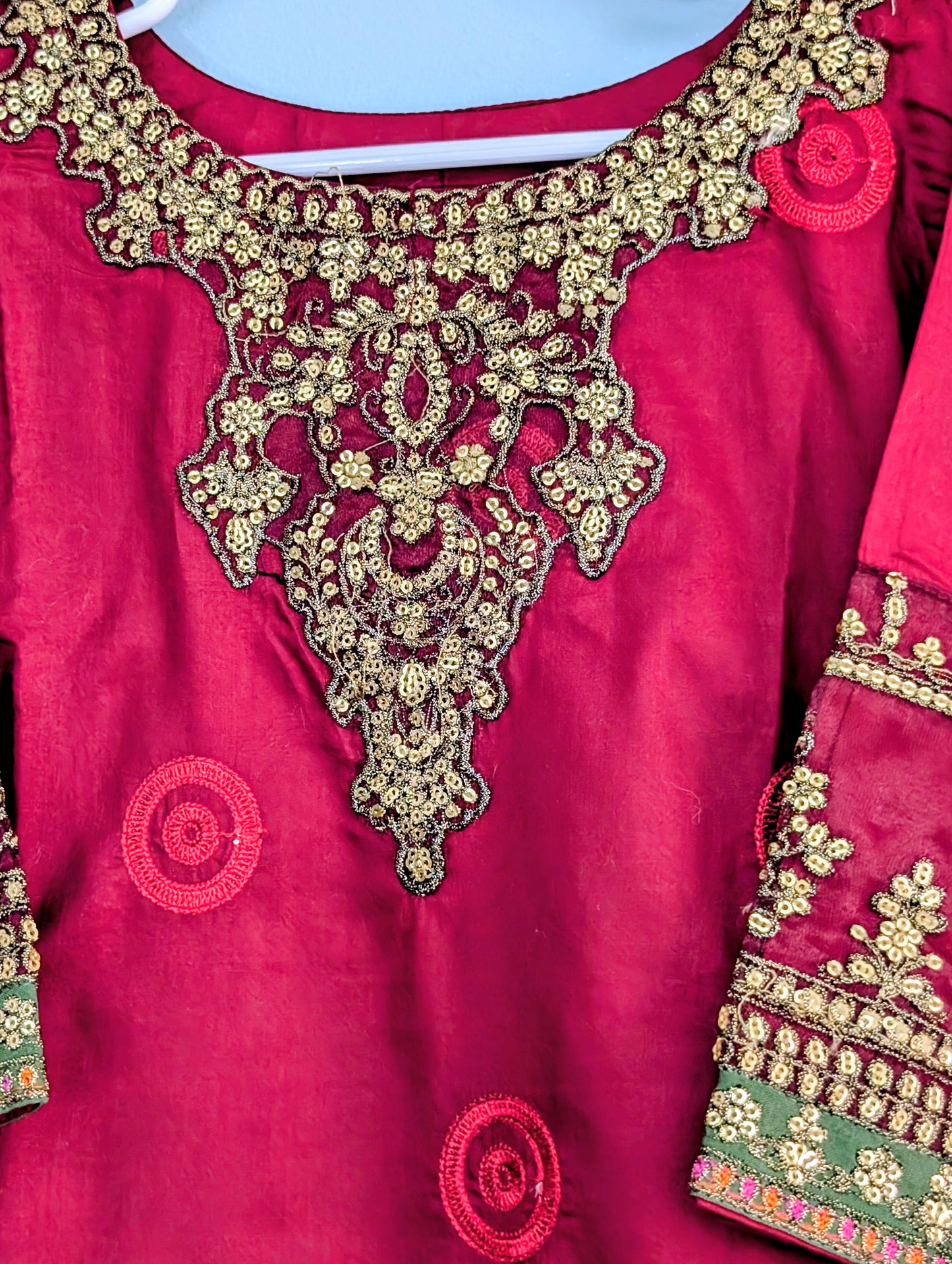 Girls maroon fully embroidered lawn kurta with matching trouser and gold dupatta.