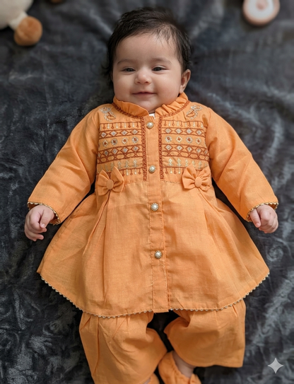 Infant  peach-orange peplum outfit  a high neckline, crystal buttons,  geometric embroidery, and matching flounced garara pants.