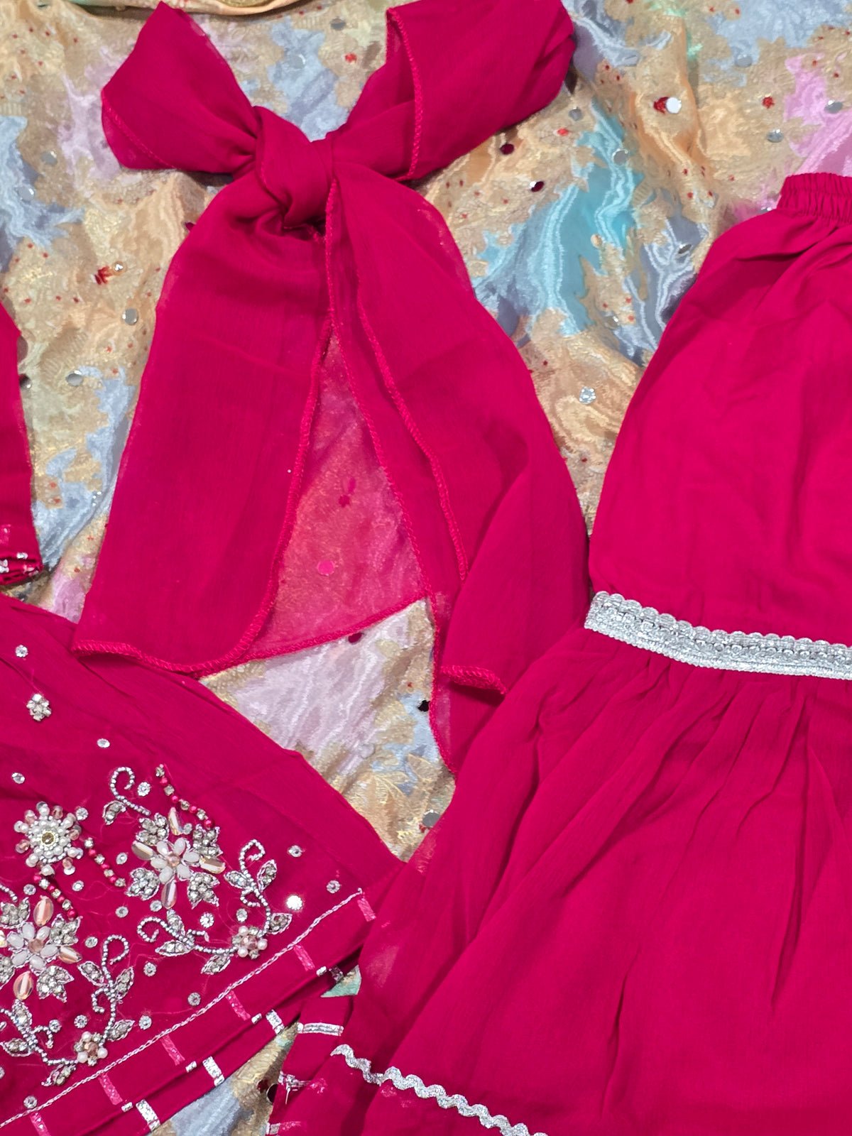 Girls magenta front-open chiffon frock featuring intricate hand embroidery, paired with a matching gharara accented by gotta lace trim and a coordinating chiffon dupatta.