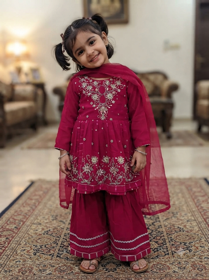 Girls magenta front-open chiffon frock featuring intricate hand embroidery, paired with a matching gharara accented by gotta lace trim and a coordinating chiffon dupatta.