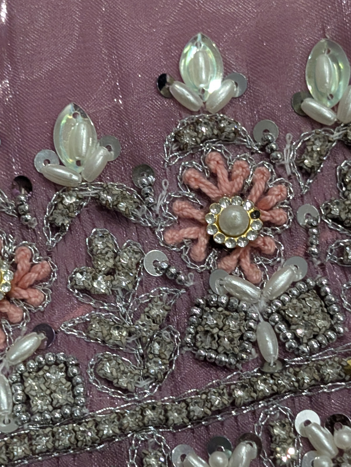 Girls' mauve kurta crafted from soft silk with an inner lining, featuring intricate hand-embellishments. It is paired with a matching gharara made from smooth, premium malai fabric and an ethereal moonlight dupatta.