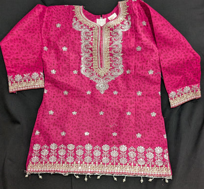 A girls' pink cotton kurta featuring a self-print and embroidery, paired with matching pants and a net dupatta.