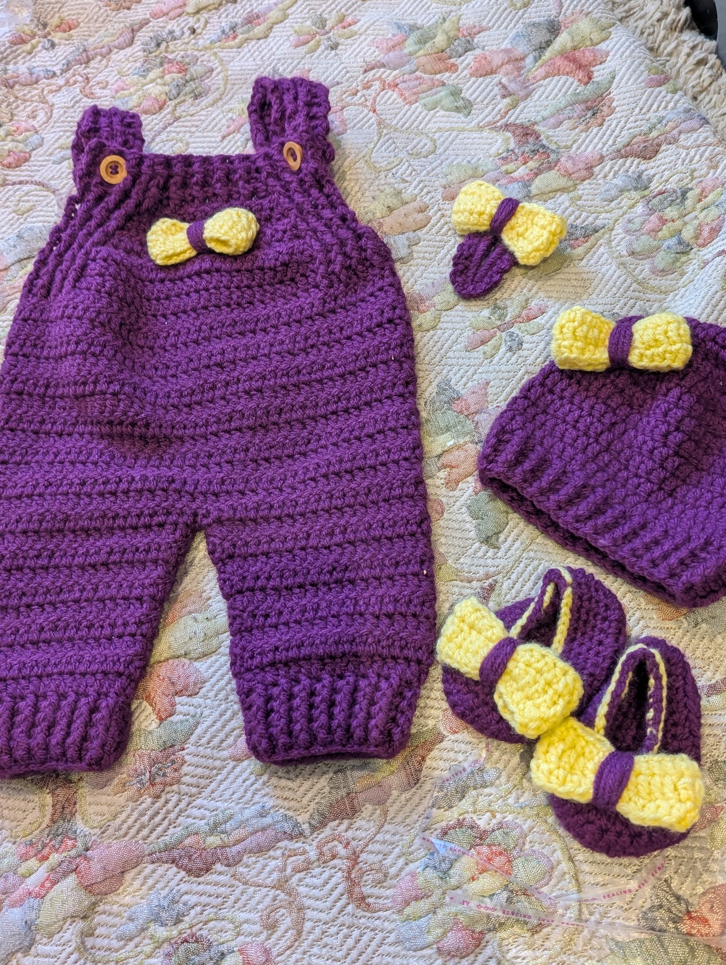 Infant girls handmade purple crochet baby set featuring a matching hat, booties, and a hair pin