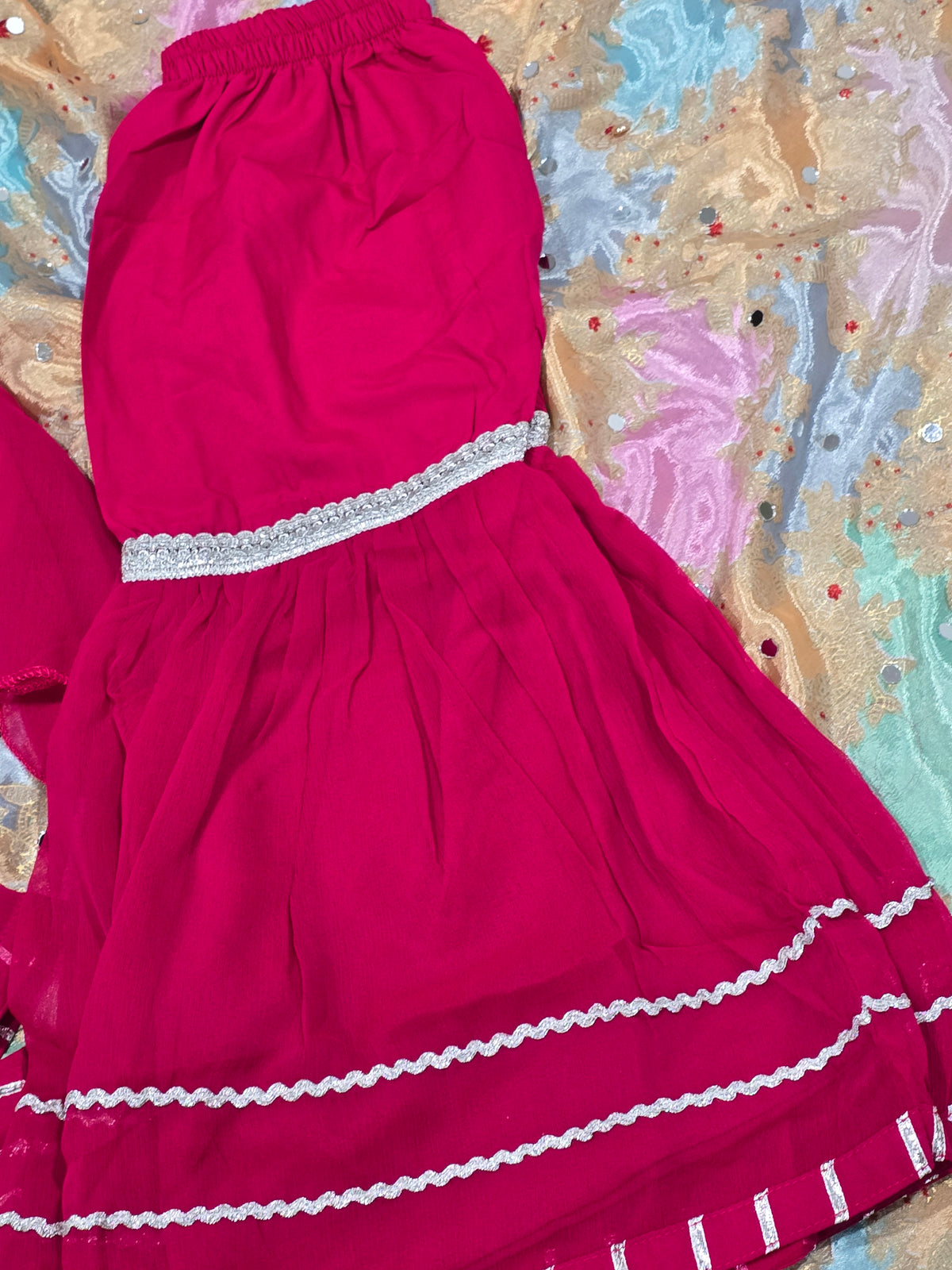 Girls magenta front-open chiffon frock featuring intricate hand embroidery, paired with a matching gharara accented by gotta lace trim and a coordinating chiffon dupatta.