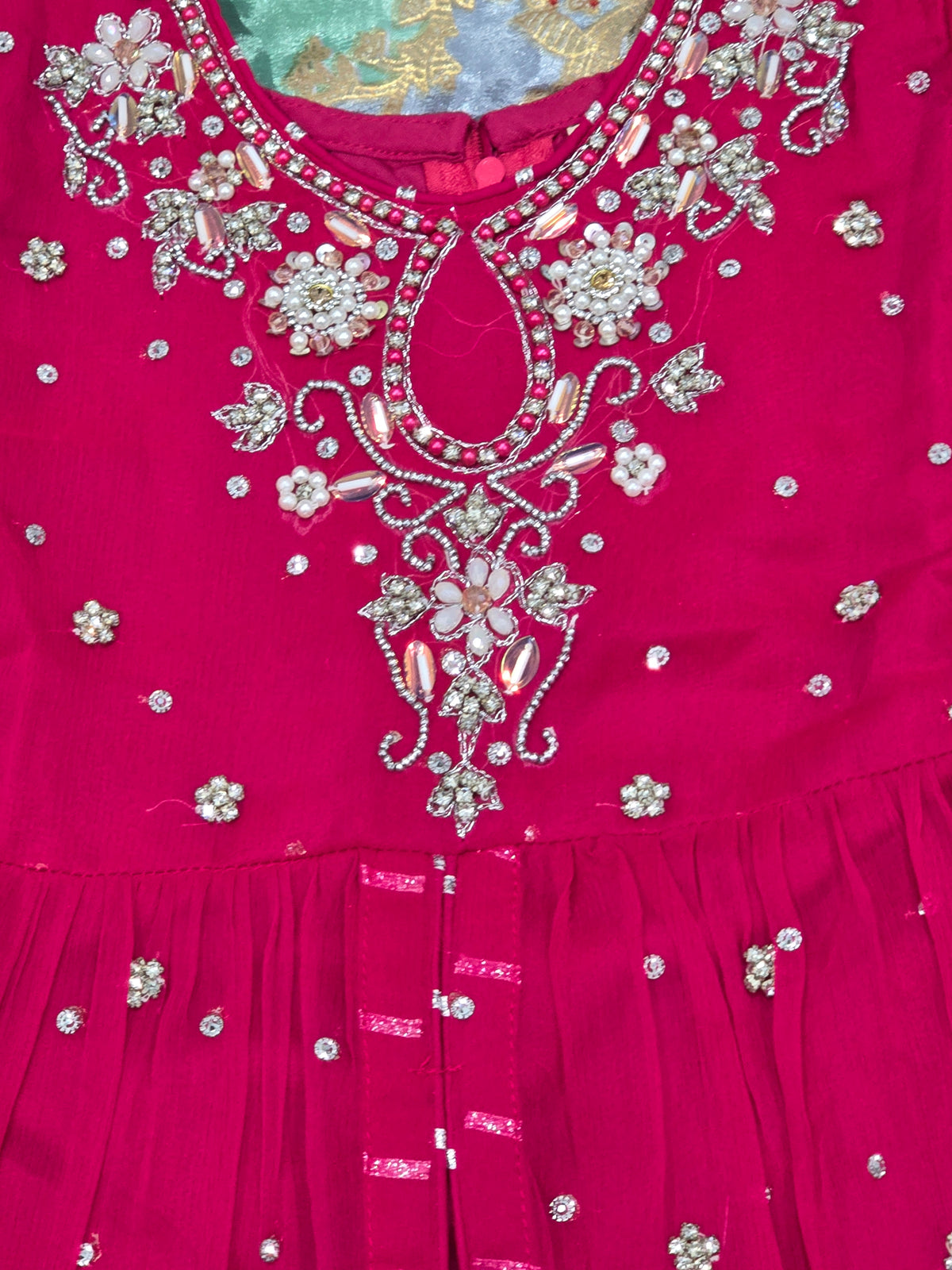 Girls magenta front-open chiffon frock featuring intricate hand embroidery, paired with a matching gharara accented by gotta lace trim and a coordinating chiffon dupatta.