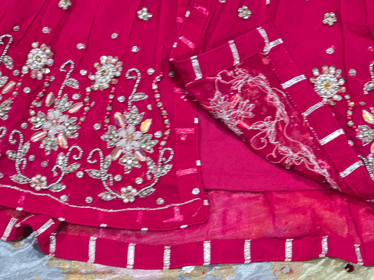 Girls magenta front-open chiffon frock featuring intricate hand embroidery, paired with a matching gharara accented by gotta lace trim and a coordinating chiffon dupatta.