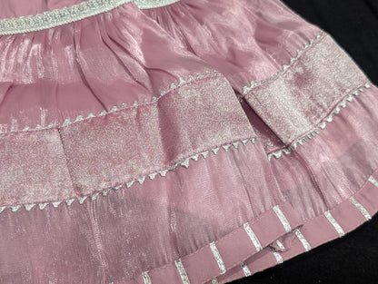 Girls' mauve kurta crafted from soft silk with an inner lining, featuring intricate hand-embellishments. It is paired with a matching gharara made from smooth, premium malai fabric and an ethereal moonlight dupatta.