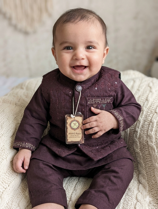 Infant maroon Kurta pyjama set featuring a textured, embroidered waistcoat,