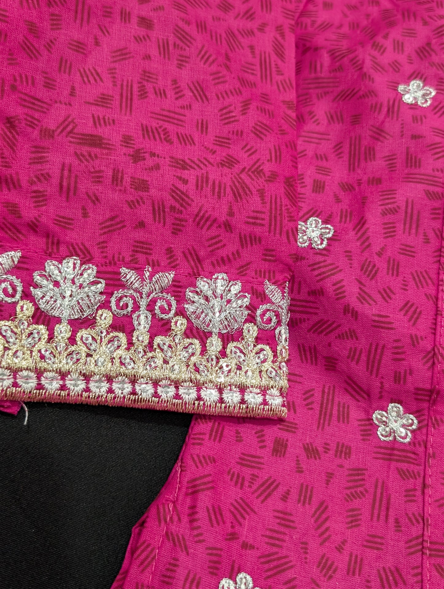 A girls' pink cotton kurta featuring a self-print and embroidery, paired with matching pants and a net dupatta.
