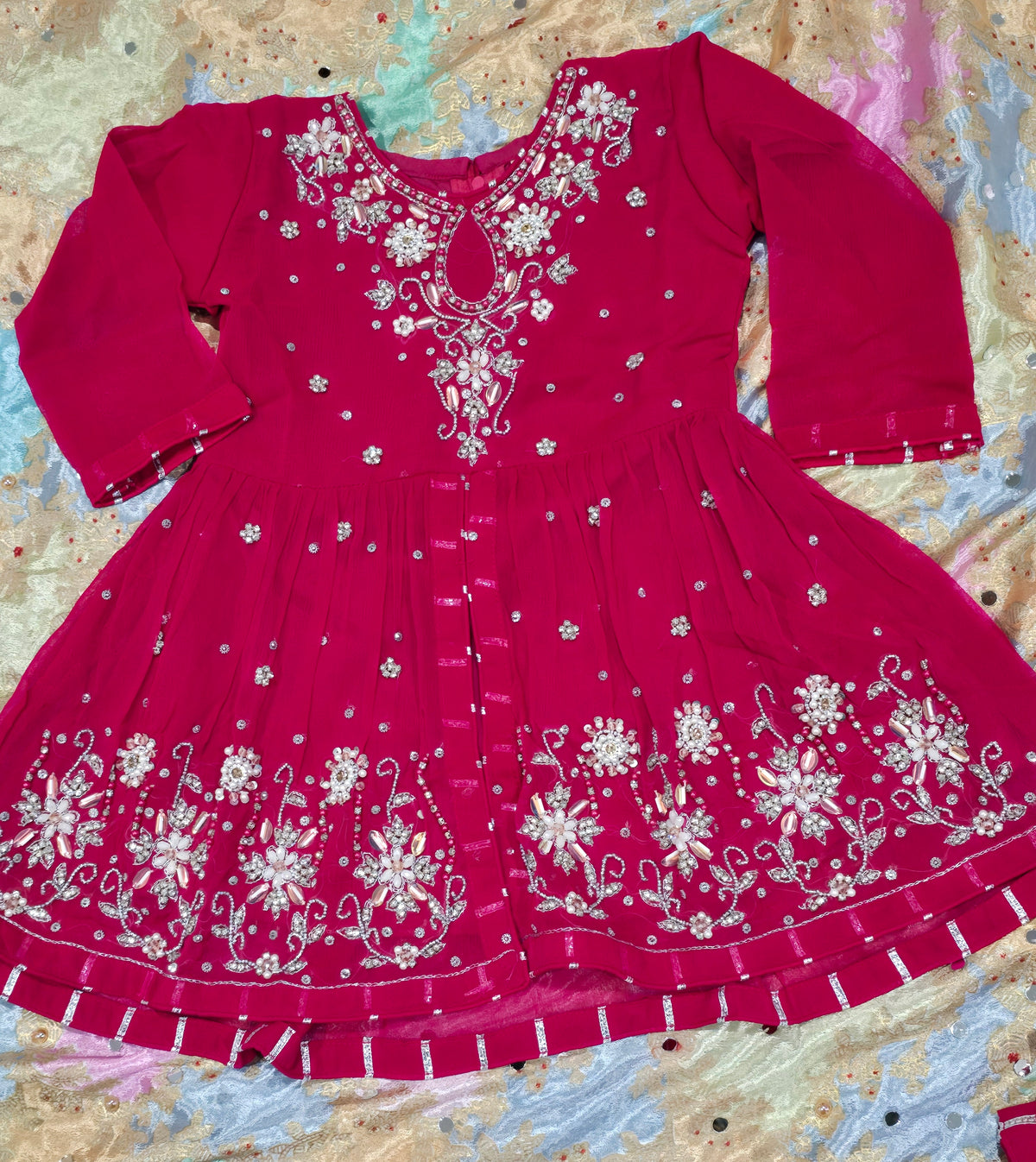 Girls magenta front-open chiffon frock featuring intricate hand embroidery, paired with a matching gharara accented by gotta lace trim and a coordinating chiffon dupatta.