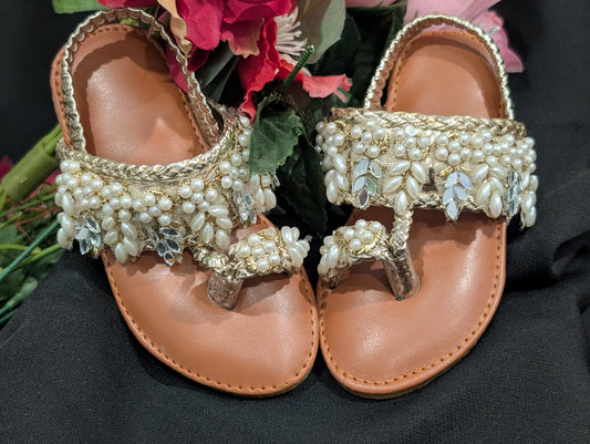 Girls wear mirrors, beaded work, and golden traditional footwear.