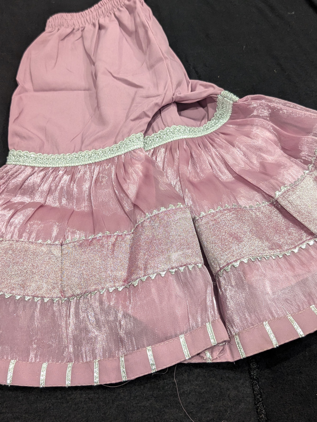 Girls' mauve kurta crafted from soft silk with an inner lining, featuring intricate hand-embellishments. It is paired with a matching gharara made from smooth, premium malai fabric and an ethereal moonlight dupatta.