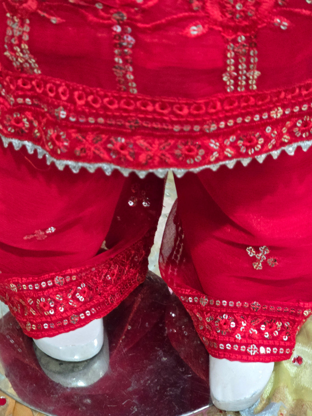 Girls Vibrant red  traditional kurta and pants set featuring intricate tonal embroidery, sequin work, and sheer sleeves.