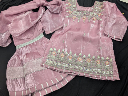 Girls' mauve kurta crafted from soft silk with an inner lining, featuring intricate hand-embellishments. It is paired with a matching gharara made from smooth, premium malai fabric and an ethereal moonlight dupatta.